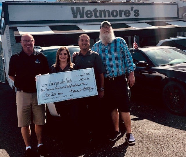 Wetmore’s team supporting the New Milford community with a donation in front of the Wetmore’s dealership